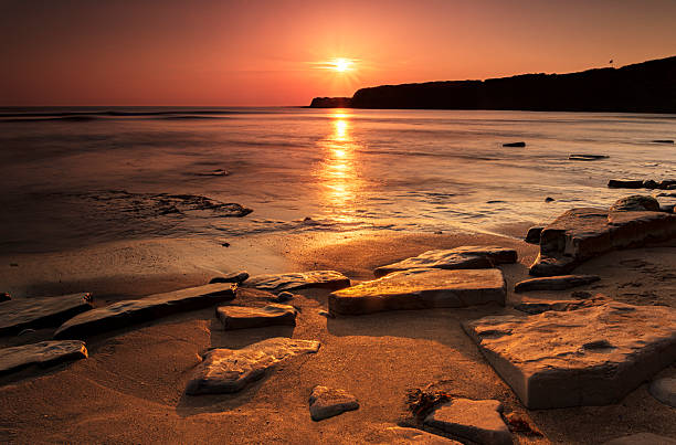 Golden hour at Kimmeridge on the Dorset Coast looking across rocks and sea
