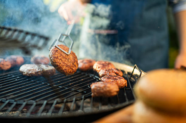 istock Woman making burgers on a BBQ at front yard. 2229815216