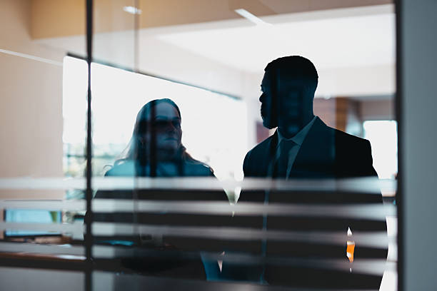 istock Business conversation behind glass wall 2229818019