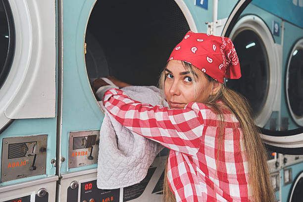 istock woman waiting for the washing process, showcasing a typical laundry routine with a thoughtful expression 2229821361