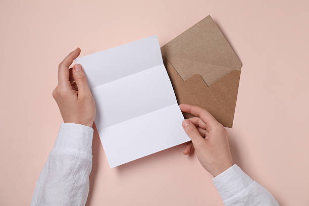 istock Woman with blank paper sheet at beige table, top view. Space for text 2229823857