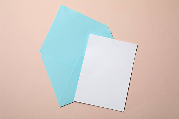 istock Letter envelope and card on beige background, top view. Space for text 2229823908