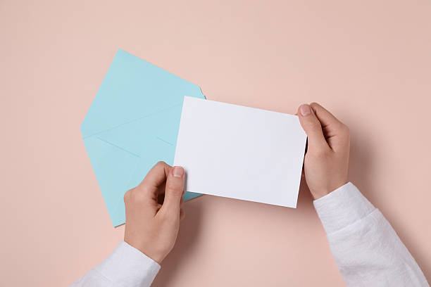 istock Woman with blank card at beige table, top view. Space for text 2229823928