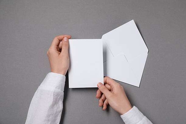 istock Woman with blank card at grey table, top view. Space for text 2229823950