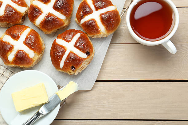 istock Tasty hot cross buns served on wooden table, flat lay. Space for text 2229826818