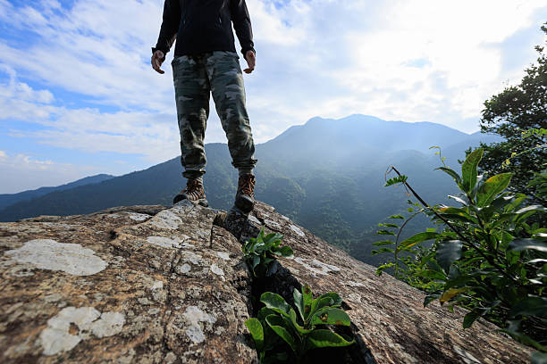 istock Successful hiker stand on sunrise mountain top cliff edge 2229827704