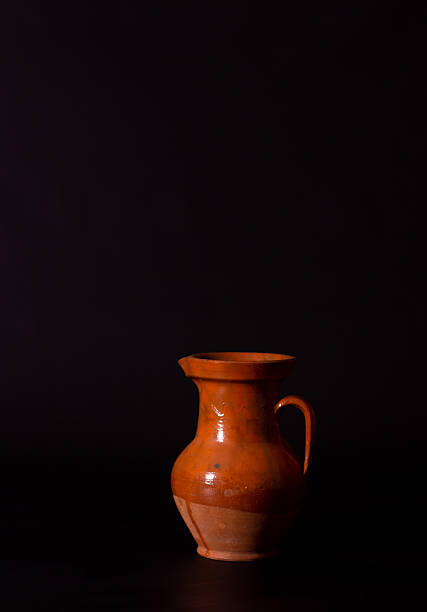 Vintage empty clay jug on black background in Kyiv, Kyiv city, Ukraine