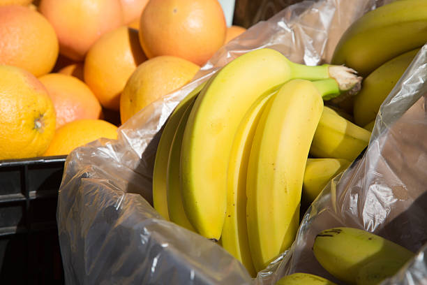 Bananas for export in a greengrocer's shop for sale abroad; in the background you can see a box of oranges.