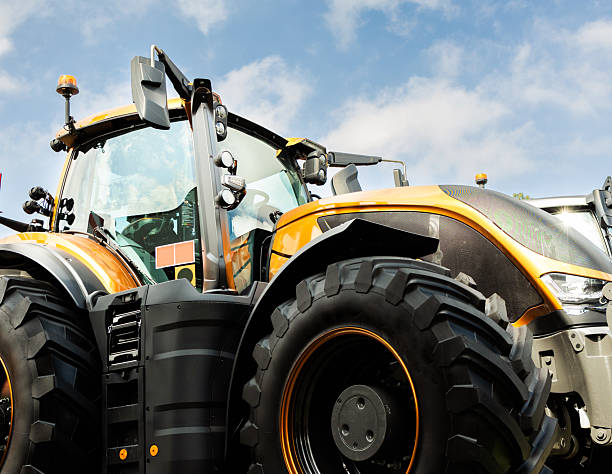 istock New agricultural tractors displayed in a row. 2229842780