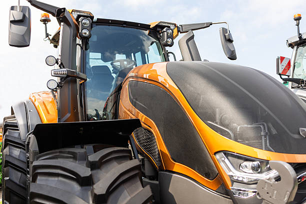 istock New agricultural tractors displayed in a row. 2229842783