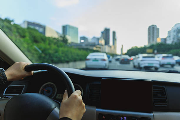 istock People driving car in modern city 2229850271