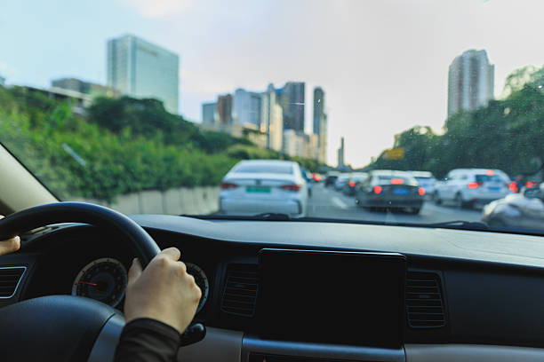 istock People driving car in modern city 2229850314