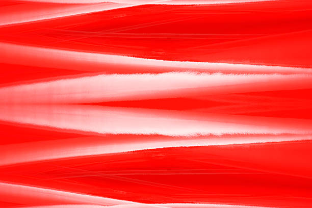 Overhead shot of red shiny vinyl wave abstract background.