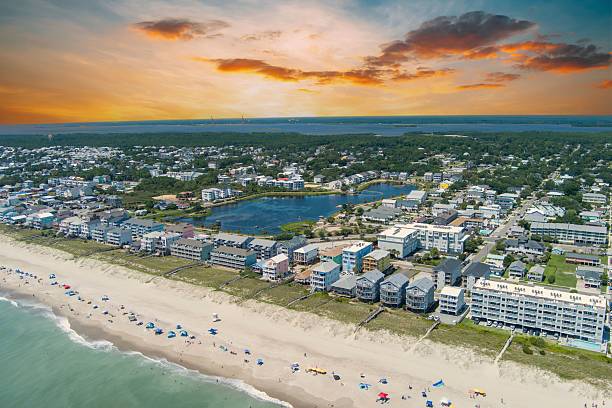 istock Aerial coastal town with beachfront and sunset sky. 2229853467