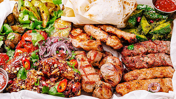Succulent grilled meats and vibrant vegetables arranged on a platter
