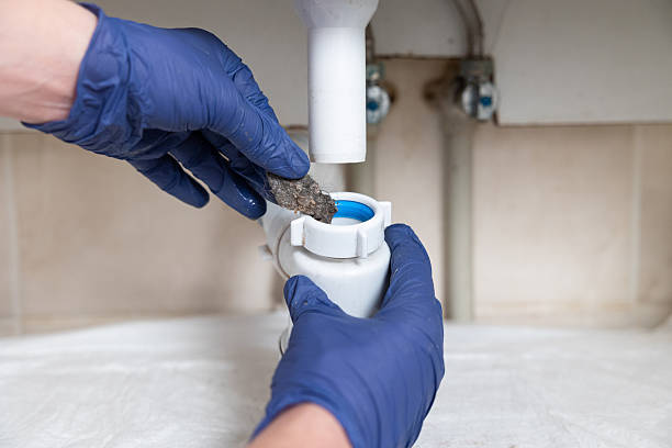 istock A man's hands clean the sink siphon from dirt. 2229858142