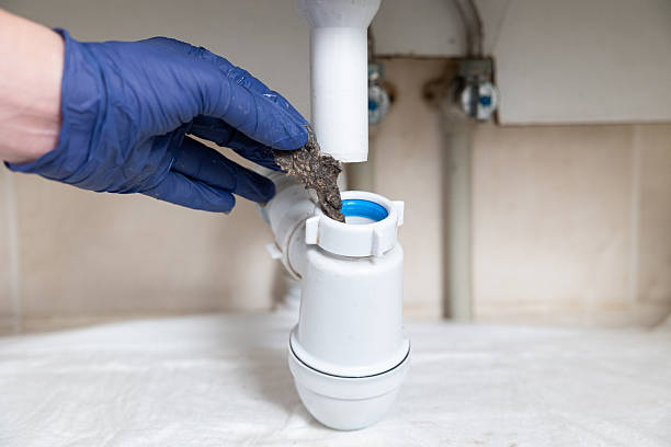 istock A man's hands clean the sink siphon from dirt. 2229858150