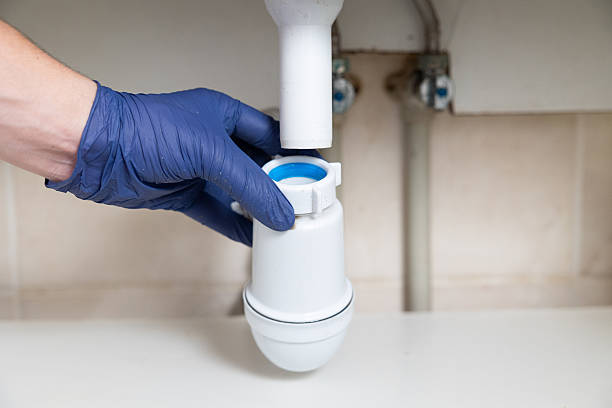 istock A man's hands clean the sink siphon from dirt. 2229858162