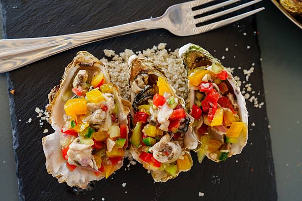 istock Delicious Oysters with Vibrant Salsa and Fork on Slate Platter, a Culinary Delight 2229859811