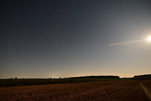istock Night Starry Sky Over the Field with Perseid Meteor Shower 2229860014