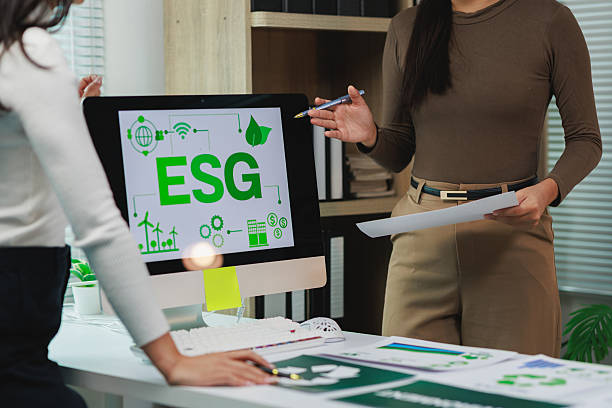 Businesswomen discussing esg investing strategy on computer screen