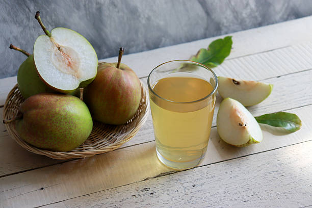 istock Freshly squeezed pear juice glass with fresh pear fruit 2229864190