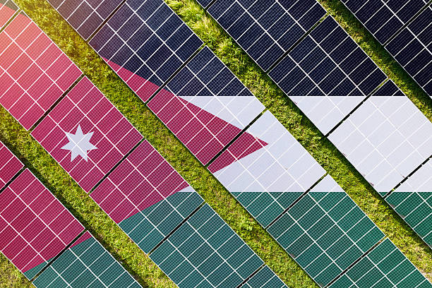 Solar farm superimposed with flag of Jordan. Symbolizing solar power and panel demand, renewable energy industry, government policy, and sustainability initiatives in the country.
