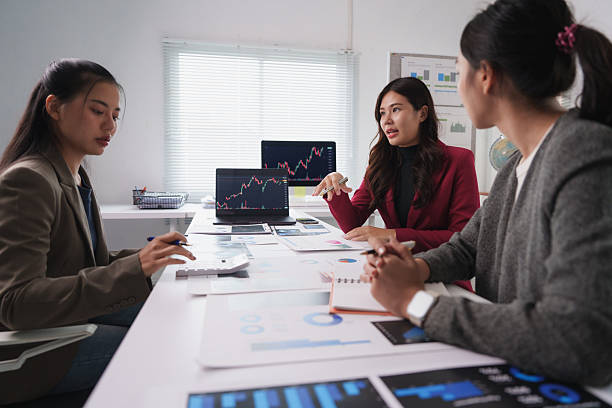 istock Businesswomen working together analyzing charts and graphs on desk 2229866185