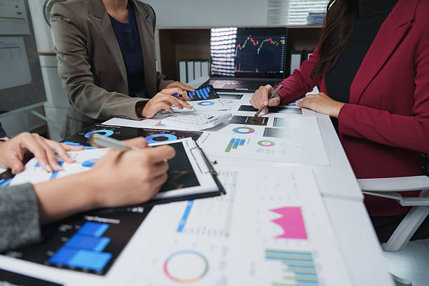 istock Businesswomen working together analyzing financial charts and graphs 2229866338