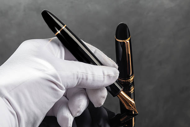 Branded fountain pen on marble gray background. Gift set. Office interior. Copy space
