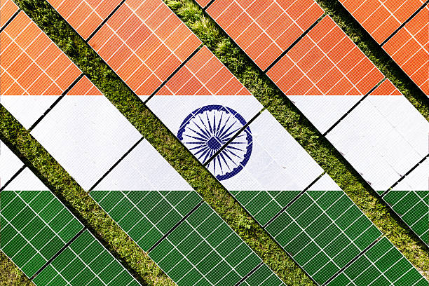 Solar farm superimposed with flag of India. Symbolizing solar power and panel demand, renewable energy industry, government policy, and sustainability initiatives in the country.