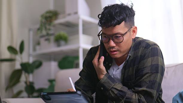 istock Business Communication – Asian Man Video Conferencing on Tablet and laptop. 2229870714