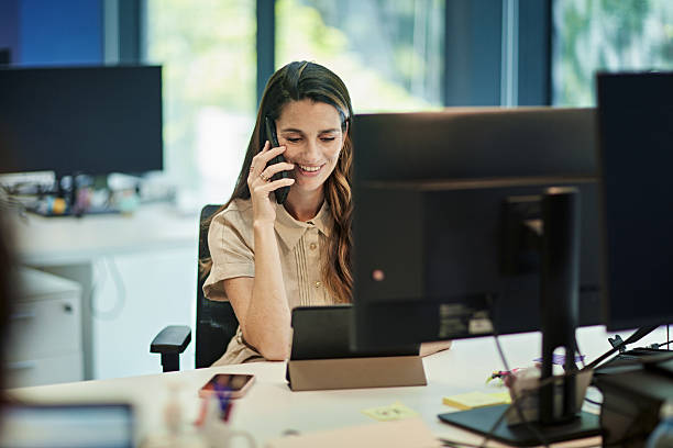 istock Smiling business professional talking with client on phone 2229874041