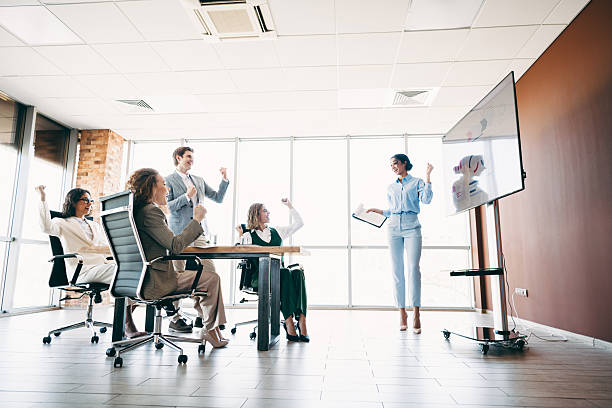 istock Professional business team collaborating on a project during a meeting in a modern office setting, celebrating success together 2229875225