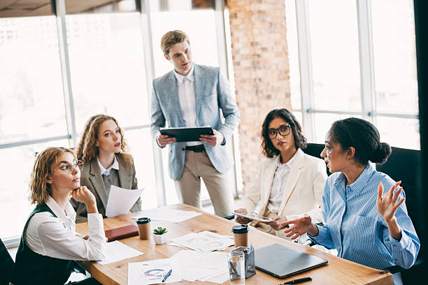 istock Diverse business team discussing a presentation during a collaborative meeting in a modern office with natural lighting 2229875334