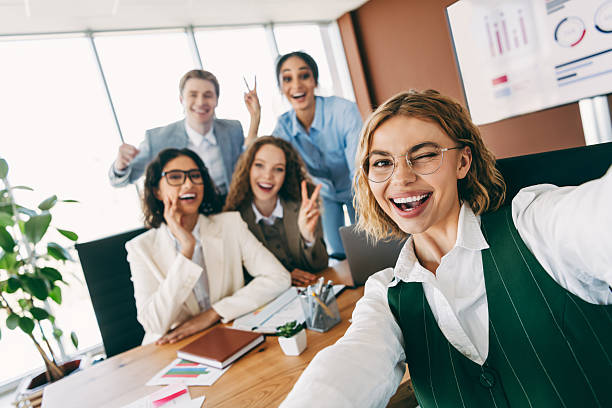 istock Group of colleagues sharing a cheerful moment in a modern office environment 2229875378