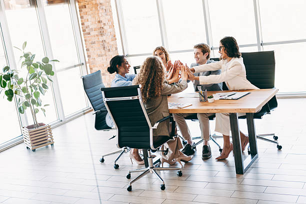 istock Professional team collaborating on a business project in a modern office environment while building teamwork and cooperation 2229875409
