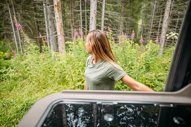 istock Woman Opening Camper Van Door in Forest 2229875849