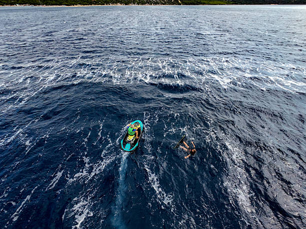 Wakeboarding Woman Towed by Jet Ski, Dramatic Cloudy Background