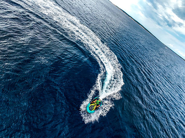 Action Shot of Elderly Man Jet Skiing on Wavy Open Water