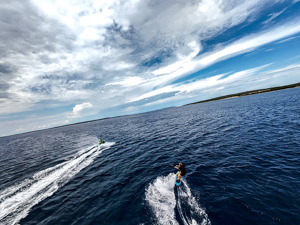 istock Female Athlete Wakeboarding behind Jet-ski in open waters 2229875876