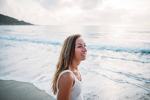 istock Woman Smiling on Beach at Sunset 2229879006