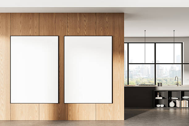 Modern kitchen interior with two blank framed posters on wooden wall paneling, large window view of cityscape and natural daylight ambiance.. 3D Rendering