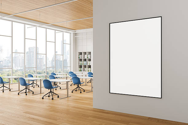 istock Blank poster on clean wall in bright modern office interior with city view through large windows and blue chairs arranged around white desks. 3D Rendering 2229881037