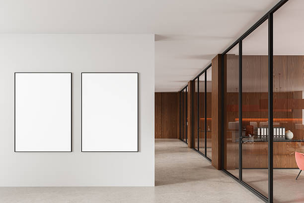 istock Two blank poster mockups on a clean white wall in a bright modern office hallway with glass and wood interior design concept. 3D Rendering. 3D Rendering 2229881625