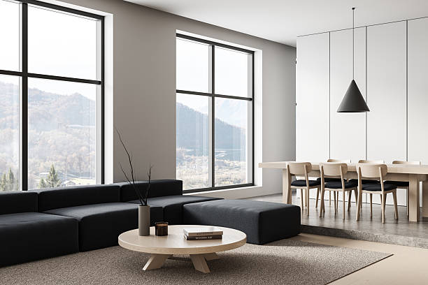 istock Modern minimalist interior with panoramic windows, neutral furniture, and natural lighting in open-concept living and dining space. 3D Rendering. 3D Rendering 2229881671