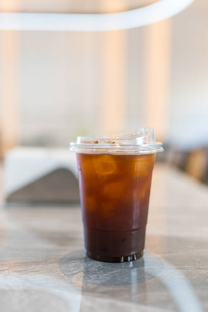 istock Glass of iced black coffee on table 2229881710