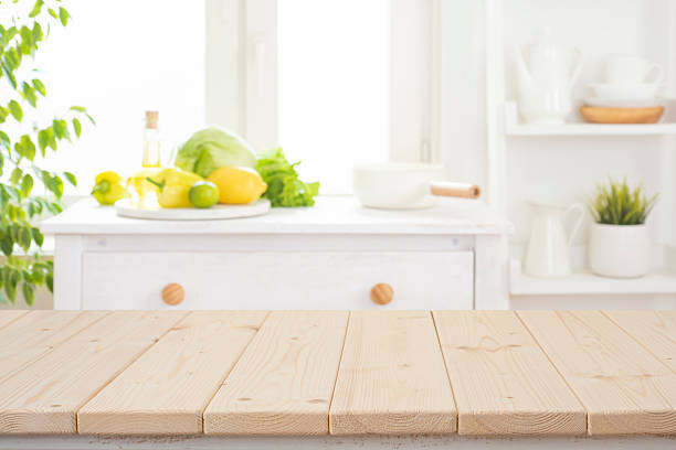 istock Empty wooden planks table for product display and defocused kitchen interior background with healthy colorful food ingredients 2229881793