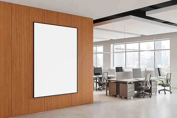 istock Blank poster mockup on wooden wall in modern office interior with open workspace and city view through large windows in daylight. 3D Rendering 2229881993