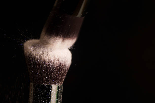 Cosmetics brush and colorful makeup powder